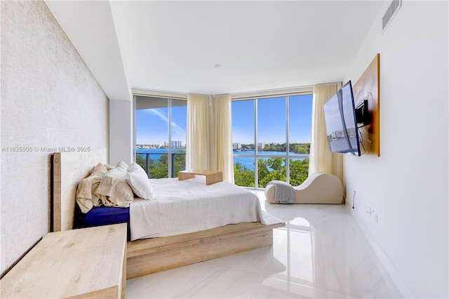 tiled bedroom with a wall of windows