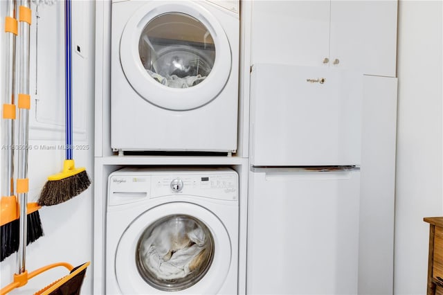 laundry area featuring stacked washer / drying machine