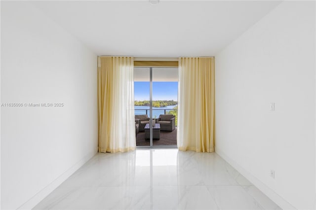 17111 Biscayne Blvd Unit 304, North Miami Beach, FL 33160 - empty room featuring light marble finish floors, floor to ceiling windows, and a water view