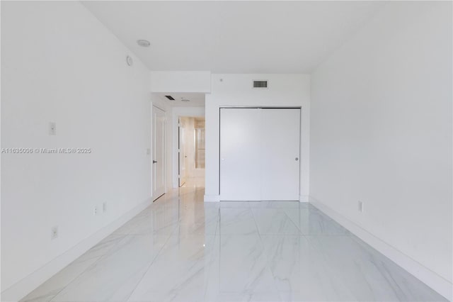 17111 Biscayne Blvd Unit 304, North Miami Beach, FL 33160 - spare room featuring light marble finish floors and baseboards