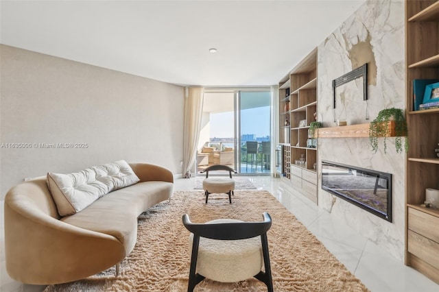 living room featuring a wall of windows and a high end fireplace