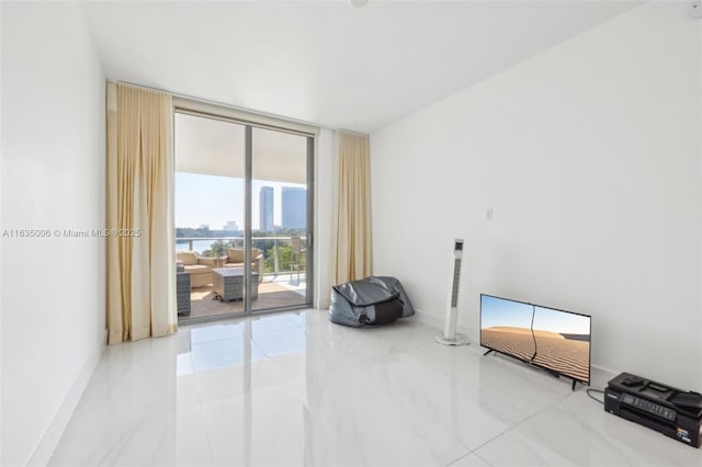 17111 Biscayne Blvd Unit 304, North Miami Beach, FL 33160 - empty room with a wall of windows and marble finish flooring