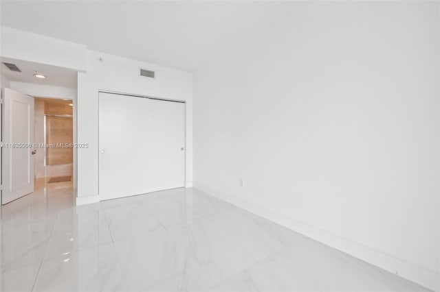17111 Biscayne Blvd Unit 304, North Miami Beach, FL 33160 - unfurnished bedroom with light marble finish floors and a closet