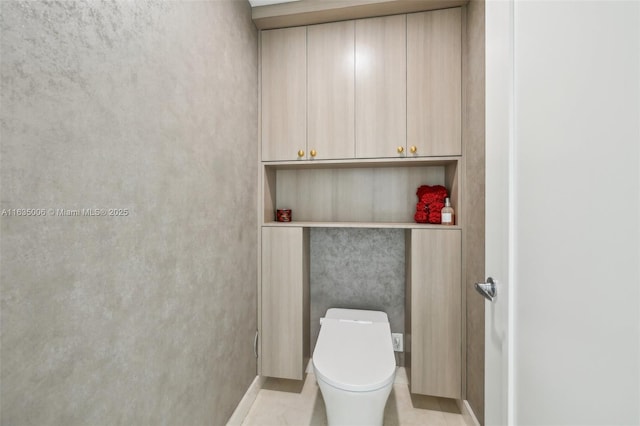 bathroom with tile patterned flooring and toilet