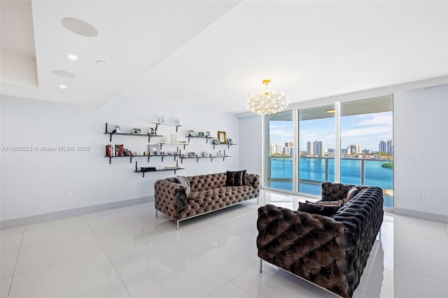 living area featuring light tile patterned flooring, a chandelier, a city view, baseboards, and expansive windows