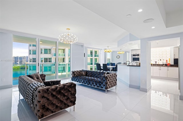 living room featuring light tile patterned floors, baseboards, recessed lighting, and a notable chandelier