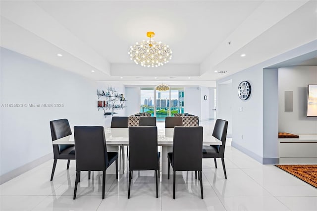 dining area featuring a raised ceiling, light tile patterned floors, and a chandelier