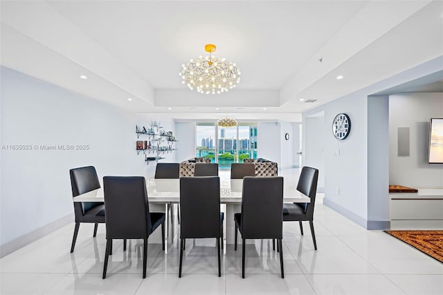 dining room with a raised ceiling, light tile patterned floors, baseboards, recessed lighting, and an inviting chandelier