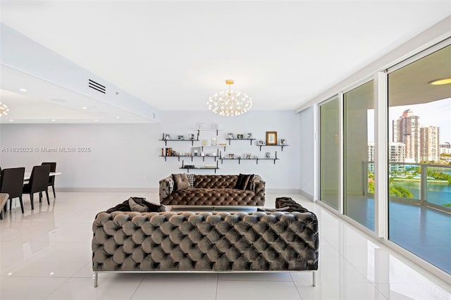 living area with an inviting chandelier, tile patterned flooring, baseboards, and visible vents