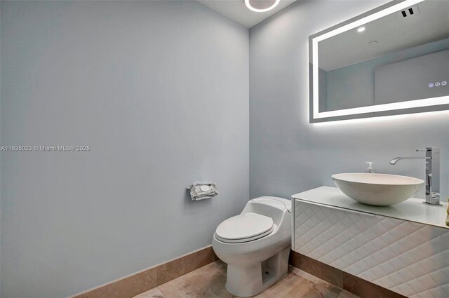 bathroom with tile patterned floors, toilet, and vanity