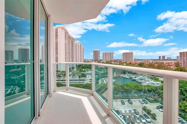 balcony featuring a city view and a water view