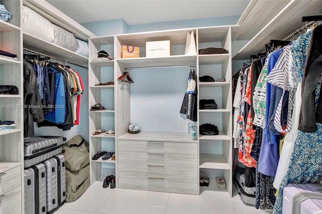 spacious closet with light tile patterned floors