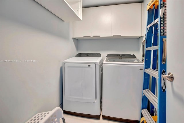 washroom with washer and dryer and cabinet space