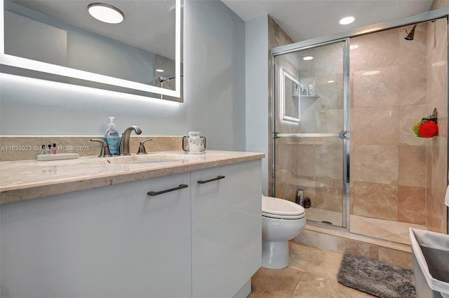 bathroom with walk in shower, vanity, and toilet