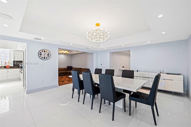 dining space featuring a raised ceiling, light tile patterned floors, visible vents, recessed lighting, and an inviting chandelier