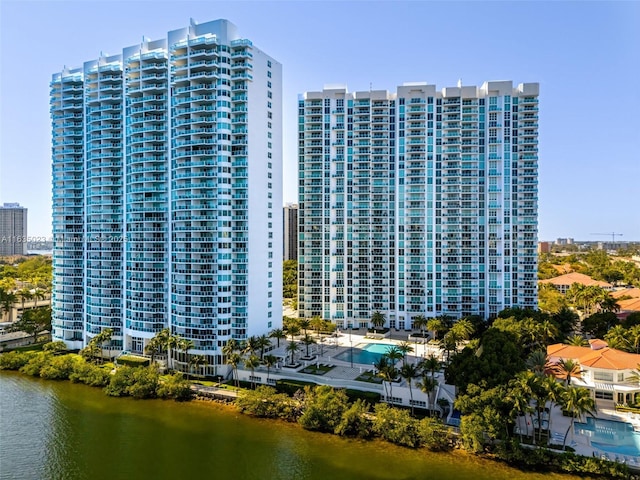 view of property featuring a water view and a view of city