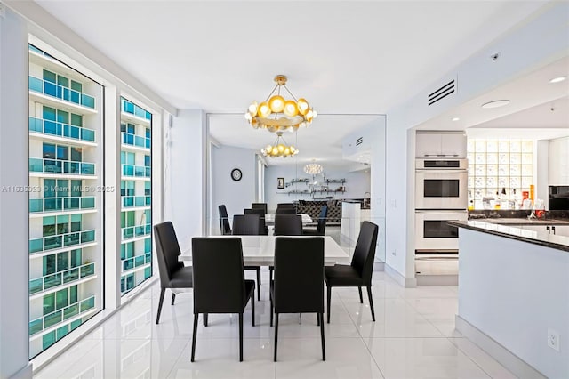 dining room featuring a healthy amount of sunlight, a notable chandelier, visible vents, and light tile patterned floors