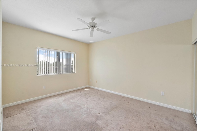 unfurnished room with light carpet, ceiling fan, and baseboards