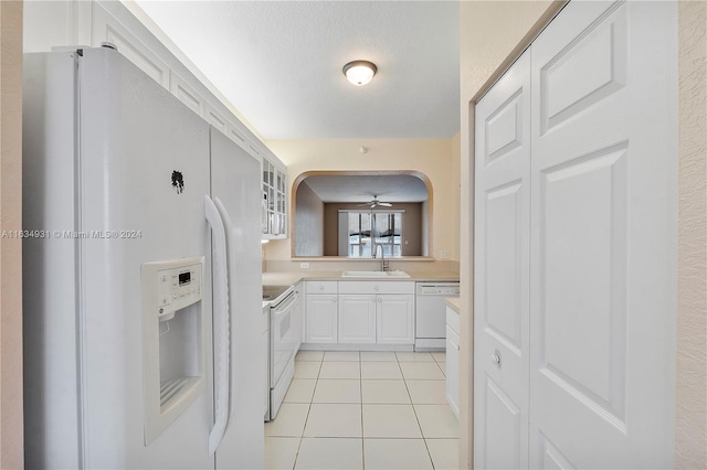 kitchen with white cabinetry, ceiling fan, white appliances, sink, and light tile patterned floors