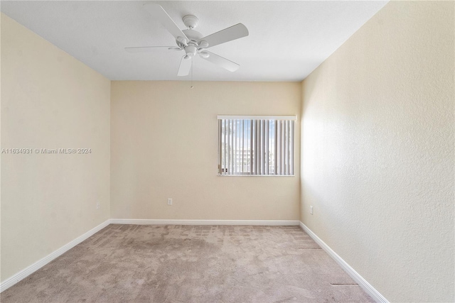 spare room with light carpet and ceiling fan