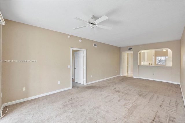 carpeted empty room with ceiling fan