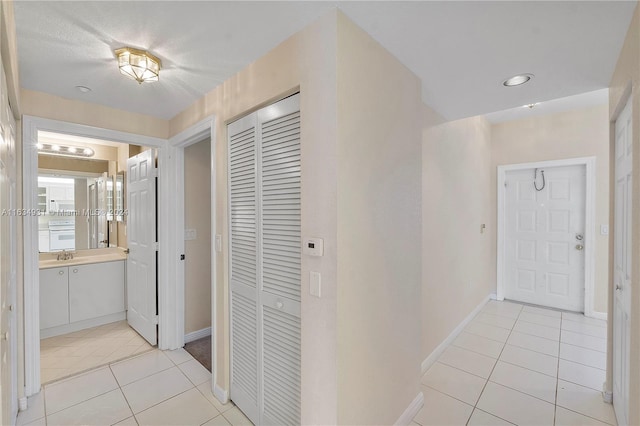 corridor featuring light tile patterned flooring