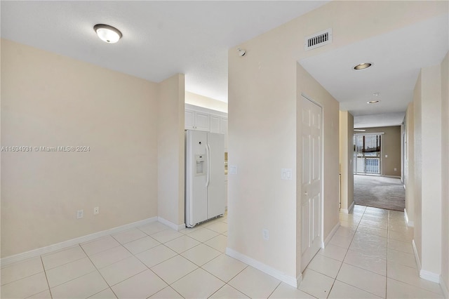 corridor featuring light colored carpet