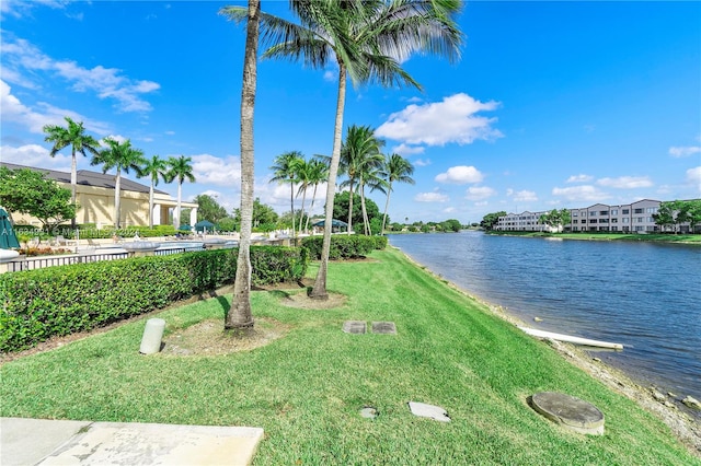 exterior space featuring a water view and a lawn