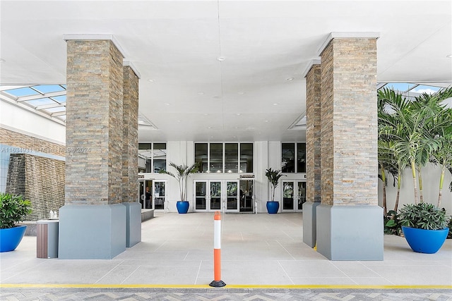 property entrance featuring a patio area and french doors