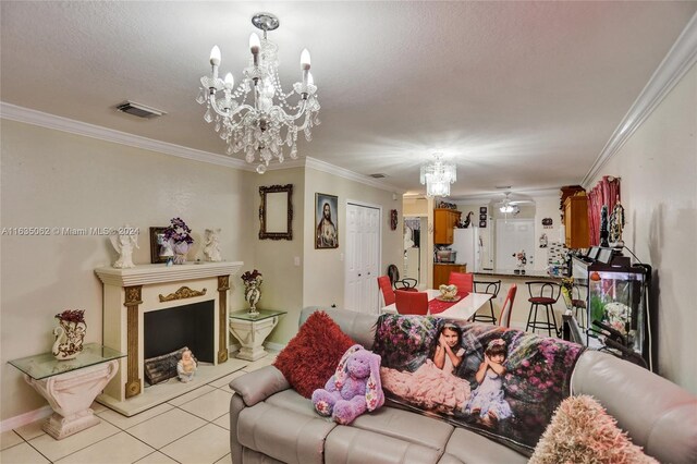 tiled living room featuring ceiling fan with notable chandelier, a textured ceiling, and ornamental molding