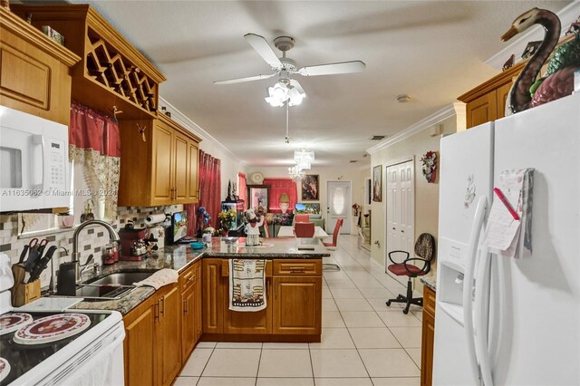 kitchen with ceiling fan, kitchen peninsula, crown molding, backsplash, and white appliances