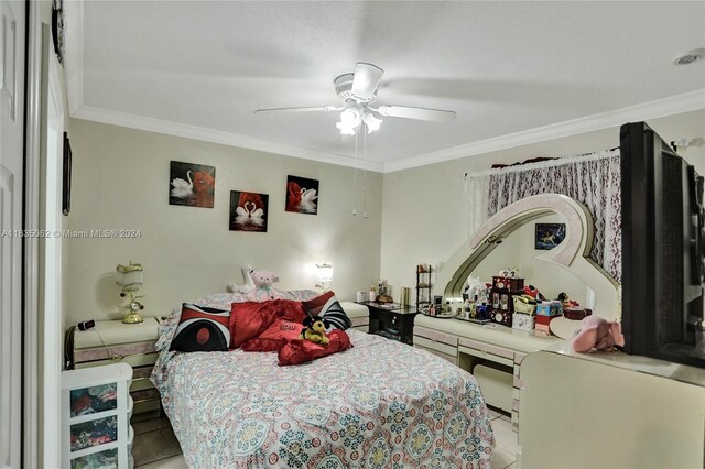 tiled bedroom with ceiling fan and ornamental molding