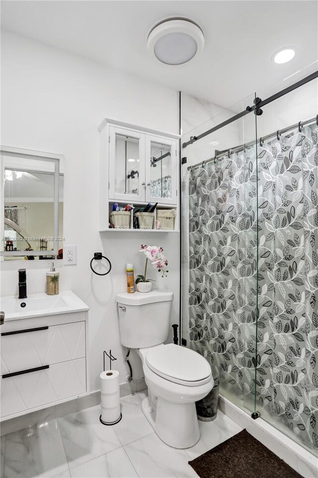 bathroom featuring sink, tile patterned flooring, and toilet