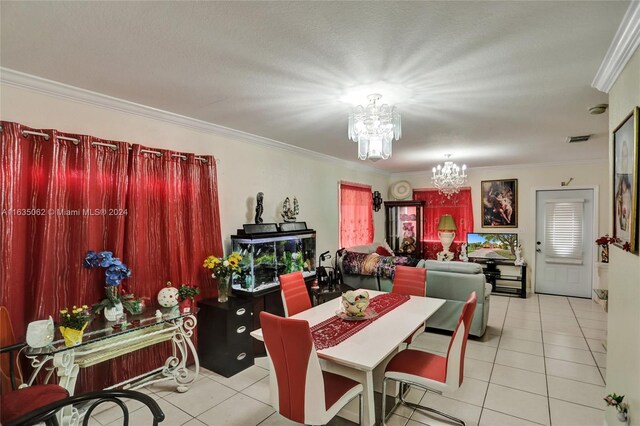 tiled dining room with a notable chandelier, a textured ceiling, and ornamental molding