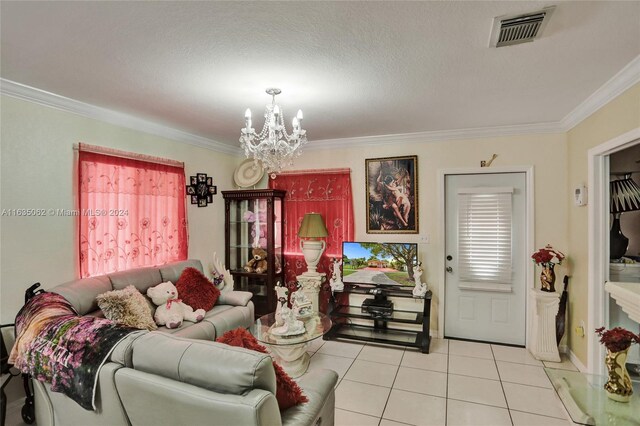 living room featuring light tile patterned flooring, a textured ceiling, crown molding, and an inviting chandelier