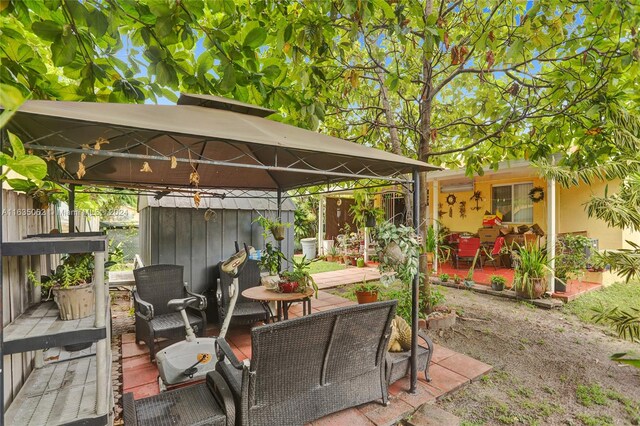 view of patio with a wooden deck and a gazebo