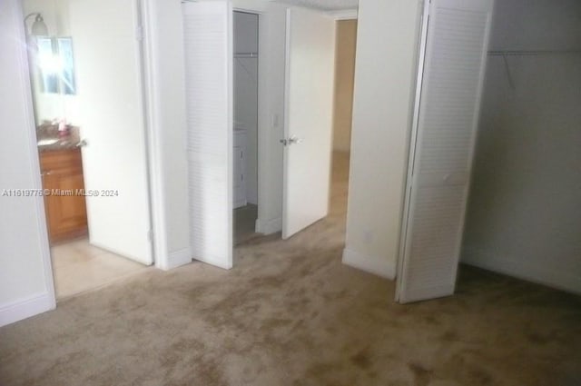 unfurnished bedroom with light carpet