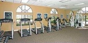 workout area with a wealth of natural light and a drop ceiling