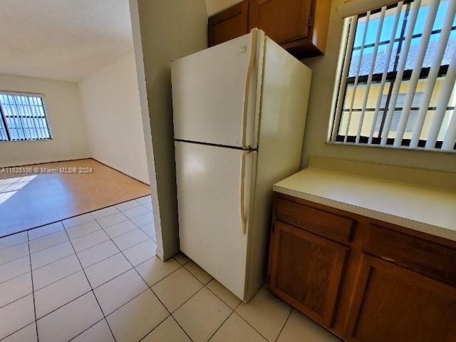 kitchen featuring light tile patterned flooring and white refrigerator