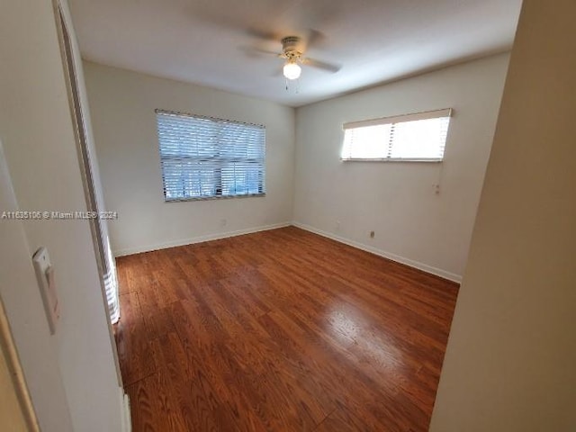 spare room with ceiling fan and wood-type flooring