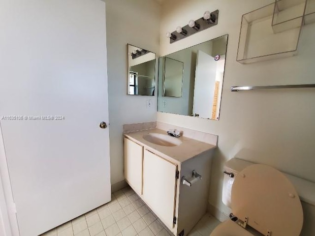 bathroom with vanity, tile patterned floors, and toilet