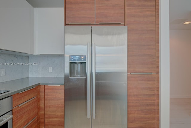 kitchen with appliances with stainless steel finishes and tasteful backsplash