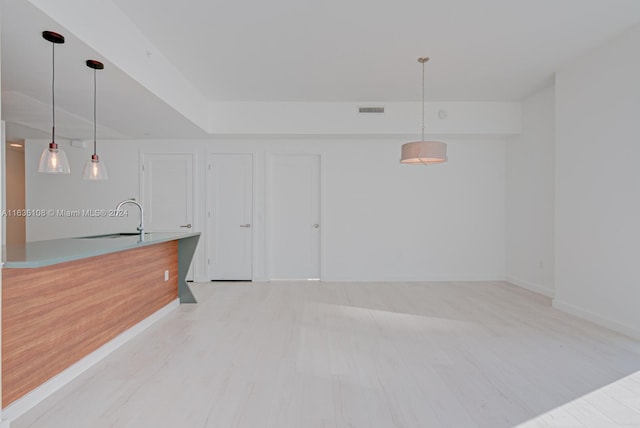 living room featuring light hardwood / wood-style floors and sink