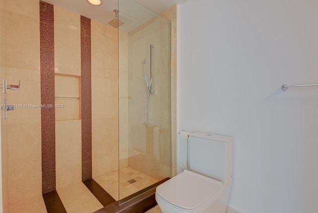 bathroom featuring walk in shower and toilet