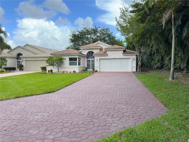 mediterranean / spanish-style home with a garage, a tile roof, decorative driveway, stucco siding, and a front yard