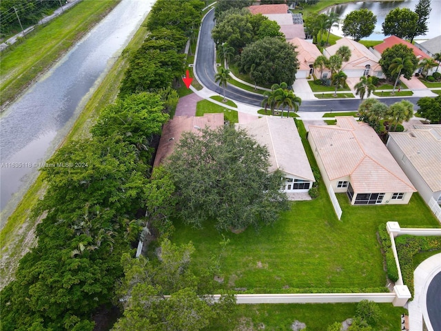 drone / aerial view with a water view and a residential view