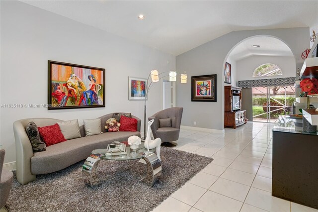 tiled living room featuring lofted ceiling