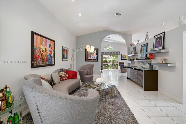 tiled living room with lofted ceiling