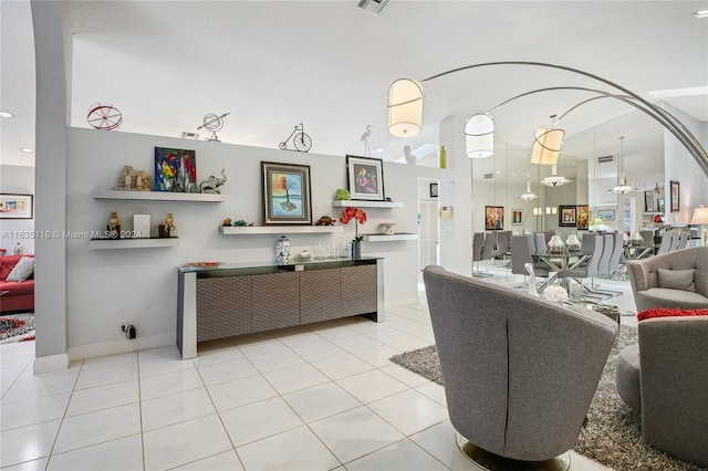 living area featuring light tile patterned floors and baseboards