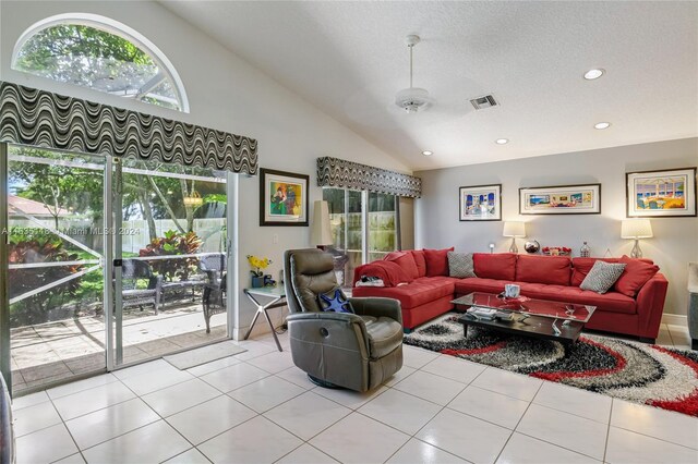 tiled living room with high vaulted ceiling, a textured ceiling, and ceiling fan